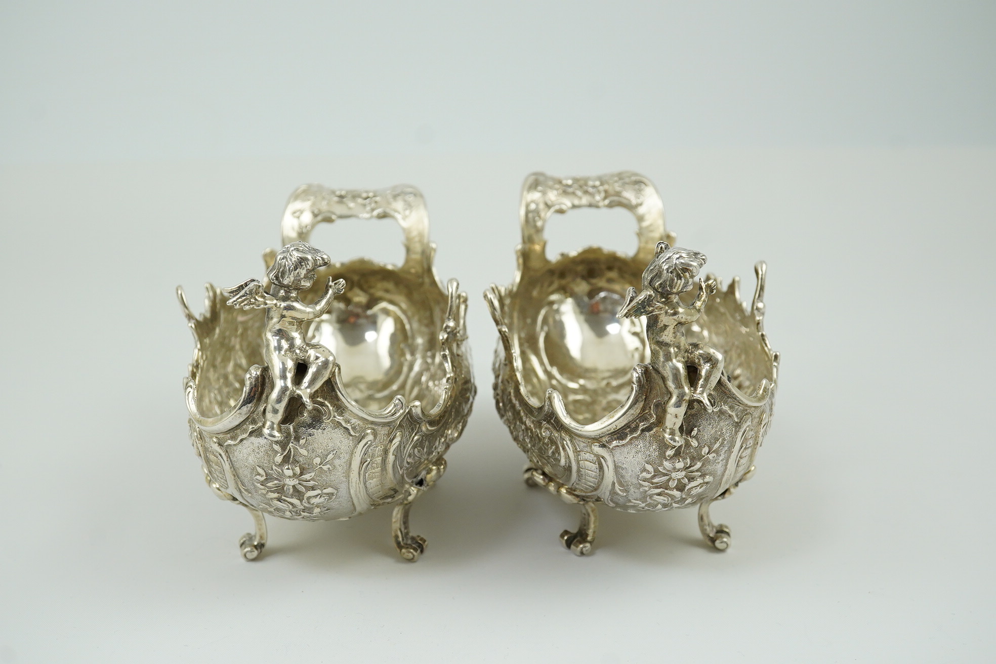 A pair of late 19th century German Hanau ornate embossed silver oval sweetmeat bowls